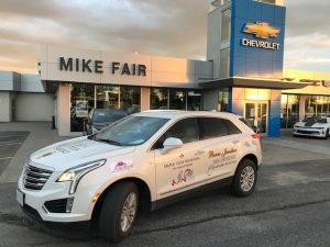 Delivery vehicle in front of Mike Fair Chevrolet